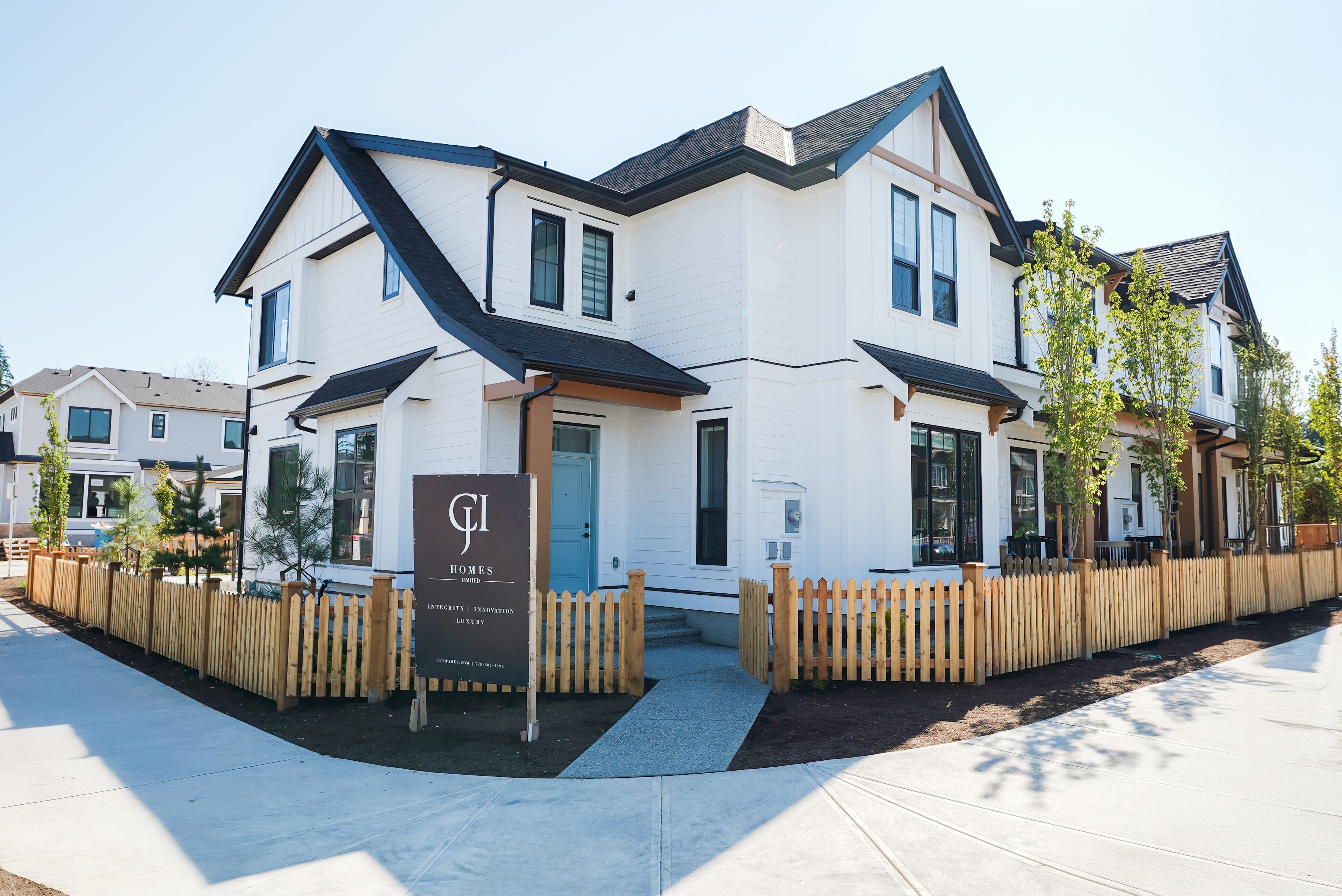 Corner exterior of a Willoughby Row home by CJI Group, showing the streetscape of attached rowhomes